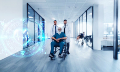 A senior patient in a teal wheelchair sits between two doctors in a modern hospital corridor.  They appear confident and reassuring.