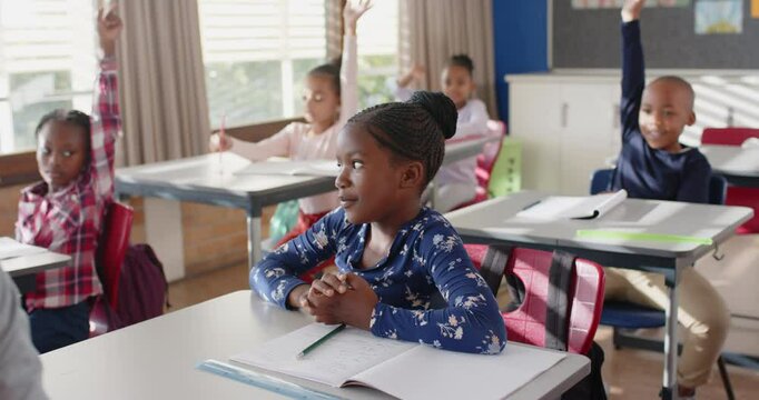 In school, students raising hands and participating in classroom discussion
