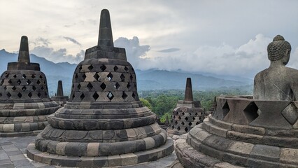 Borobudur Buddhist Temple on a sunny day with mountain view in Yogyakarta, Java, Indonesia