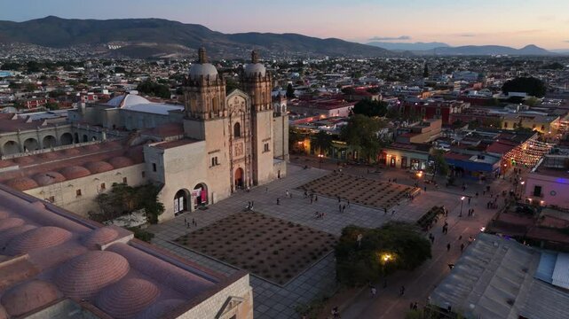 dusk flying counter clockwise around plaza in front of Templo de Santo Domingo in Oaxaca