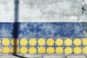 Obraz premium Vibrant Wall Decoration Featuring Beautiful Yellow and Blue Tiles with Textured Gray Background, Perfect for Interior Design and Architectural Inspiration