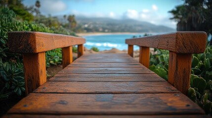 Fototapeta premium Wooden footbridge leading to California beach with ocean view.