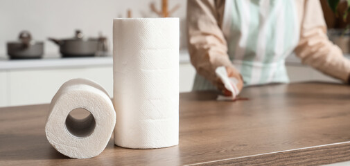 Rolls of paper towels on table in kitchen, closeup