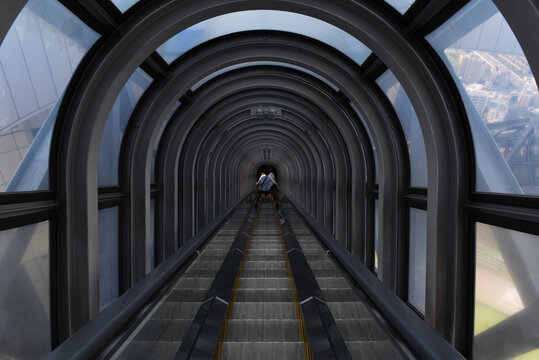 People going down a very long escalator