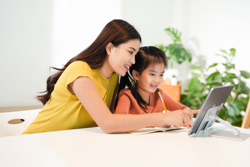 Asian parent teaching homework to children and participate e-learning online education class group...