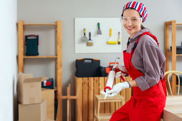 Female worker with sealant smiling in room