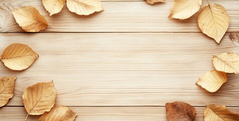 Autumn leaves frame on light wood background.