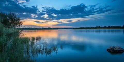 Fototapeta premium Stunning landscape featuring serene water in a beautiful evening mood. The enchanting water, whether from a sea, lake, or river, is one of nature s most captivating elements, enhancing every getaway.