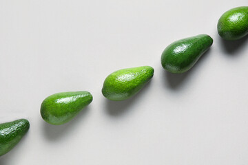 Fresh ripe avocados on grey background