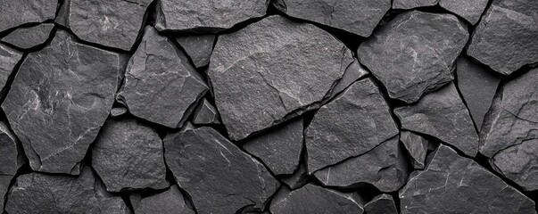 Fototapeta premium Grunge texture background concept. Textured black stone wall with irregular shapes and patterns.