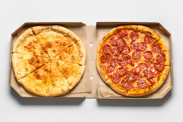 Cardboard box with tasty pizza on white background