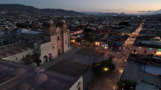 sunset flying past Templo de Santo Domingo towards view of Oaxaca