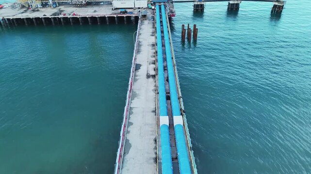 Aerial View of Coastal Industrial Pier with Blue Pipelines. Bintauna North Sulawesi.	