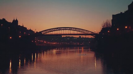 Obraz premium Sunset Reflection Over River with Bridge and City Lights