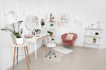 Interior of hairdressing salon with table, armchair and shelf units