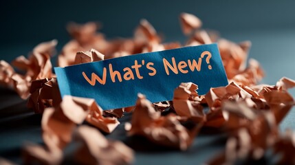 What's New?  A Blue Note Amidst Crumpled Papers, Symbolizing Fresh Ideas and Innovation.