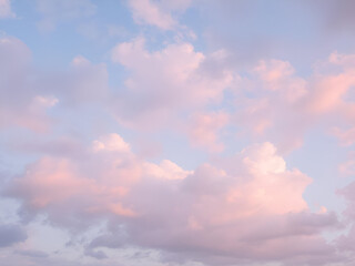 Peaceful pink and blue evening sky with soft clouds.