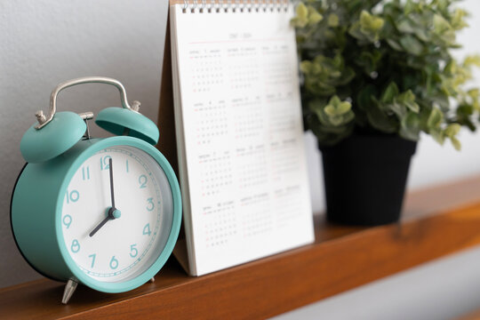 close up of alarm clock and calendar in the bedroom in the morning, life style concept