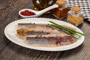 Salted marinated herring fillet with spices