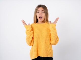beautiful caucasian teen girl wearing orange sweater Mock up copy space. Using mobile phone, typing sms message