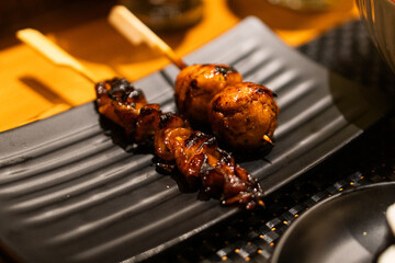 Delicious Grilled Skewers on a Black Plate