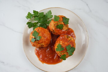 Le boulet with tomato sauce. Beef and pork meatballs in tomato sauce on a plate
