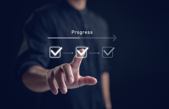 Businessman touching to tick correct mark in checklist with progressive loading status to remind work task progressive for project develop management and tracking concept.