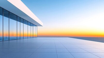 A white minimalist building with large floor-to-ceiling windows overlooking the sea.