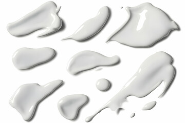 White Cream Smears and Drops Form a Variety of Abstract Shapes on White Background