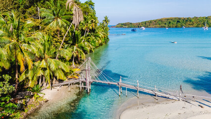Serenity of Koh Kood: A tropical paradise with a tranquil wooden bridge at sunset
