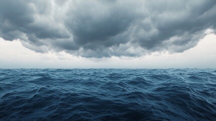 Fototapeta premium A dramatic view of dark, stormy clouds hanging over a vast, turbulent ocean, creating a sense of impending weather.