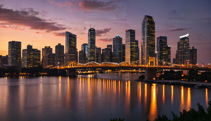 Fototapeta premium Coucher de soleil sur la ville illuminée
