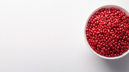Red adzuki beans in a white bowl on a clean background