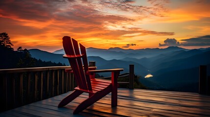 A cozy Adirondack chair sits on a wooden porch offering a breathtaking view of the mountains as the sun dips below the horizon casting a warm golden glow over the serene and picturesque scene