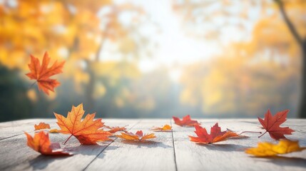 Rustic wooden table top with autumn leaves. Bright fall colors. Defocused background. Empty space for product placement. Suitable for banners, posters marketing visuals. Perfect for autumn themes.