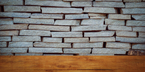 The background is blank wooden boards and a textured brick wall with lighting and vignetting.