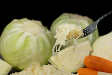 Sauerkraut salad traditional recipe consisting of cabbage, carrots, salt and peppercorns.