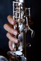 Fototapeta premium Hands playing a silver saxophone