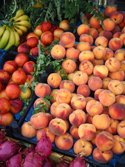 Fruit at the market. Peaches, bananas, pitaya