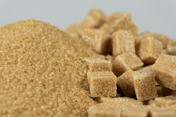 Brown cane unrefined demerara sugar in the form of crystals and cubes