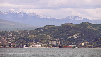 Fototapeten Sommer Coastline of Sukhumi - the main city of Abkhazia. Popular tourist resort in Sukhum town on Black sea.  © bonilook