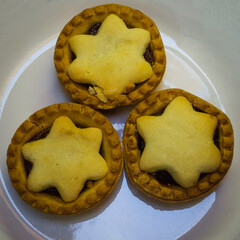 Festive Star-Topped Mince Pies on a White Plate