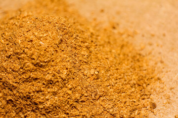 close up of cinnamon powder on brown background
