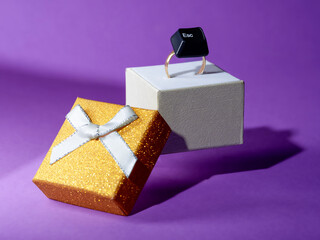 Close-up of a computer esc key on a gold ring in a ring box