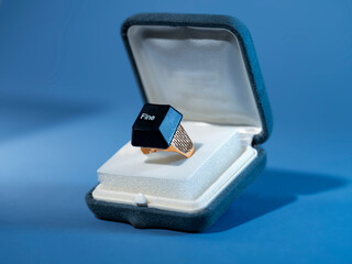 Close-up of a computer key with the word fine glued onto a ring in gift box