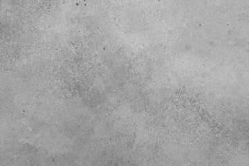 Gray stone background with imitation cement wall. Top view. Free space for text or design.