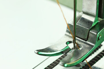 Sewing machine with thread on white background, macro view. Space for text