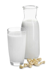 Fresh cashew milk in glass, carafe and nuts isolated on white