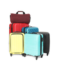 Many colorful suitcases and bag isolated on white