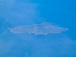 evocative image of the Isola del Giglio in front of Grosseto (Tuscany) 
in Italy seen from an airliner